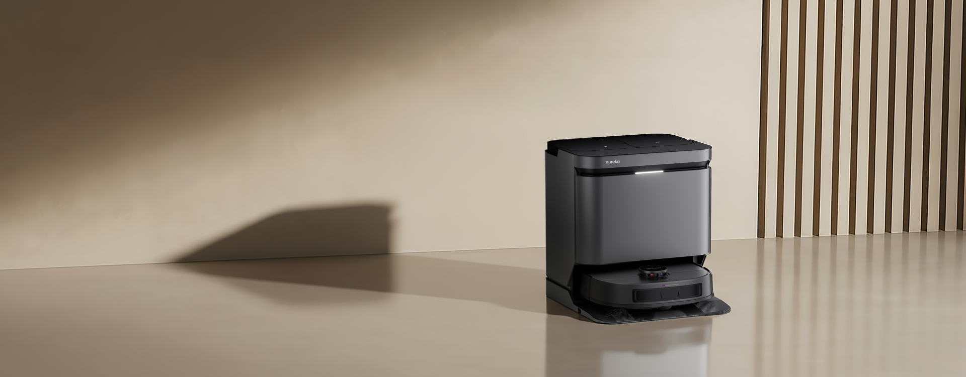 Robotic vacuum cleaner on a beige surface with a neutral background
